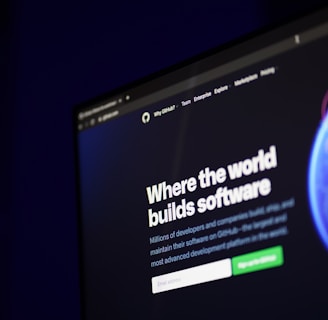A computer screen displays a website with the text 'Where the world builds software' prominently featured. Below the text, there are fields for users to input their email address, along with additional descriptions about the platform and its capabilities. The website has a dark background with bright text, indicating a professional tech-based service.